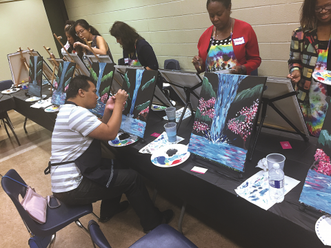 RN John De Guzman (seated) was among a large group of creative nurses to gather Sept. 21 to enjoy an evening of networking, creativity (through painting), and self-care at the Burrows Hall Community Centre in Scarborough. The event was hosted by RNAO’s Region 7. 