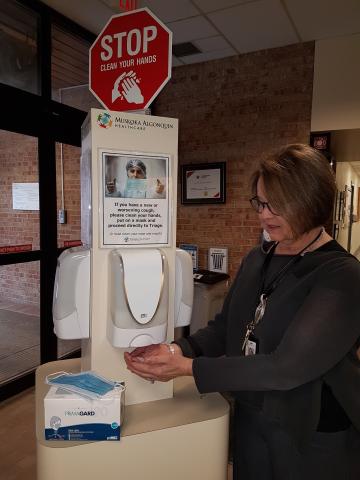 CEO and chief nurse Natalie Bubela shows how to use the sanitizing station at Muskoka Algonquin Healthcare. 