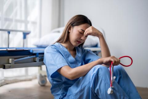 Stock image of exhausted health-care worker