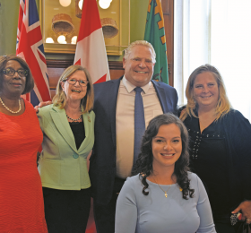RNAO member and PC MPP for Mississauga, Natalia Kusendova (seated). She is pictured here at her official swearing-in with (from left) RNAO President Angela Cooper Brathwaite, RNAO CEO Doris Grinspun, Premier Doug Ford and RNAO member Leslie Silvestri.  