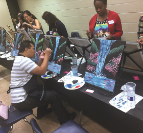 RN John De Guzman (seated) was among a large group of creative nurses to gather Sept. 21 to enjoy an evening of networking, creativity (through painting), and self-care at the Burrows Hall Community Centre in Scarborough. The event was hosted by RNAO’s Region 7. 