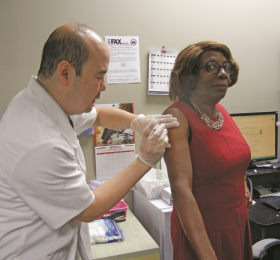 RNAO President Angela Cooper Brathwaite receives her annual flu shot at a Whitby pharmacy. Flu shots are available from RNs and NPs, and at participating pharmacies and local public health units across the province. 