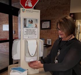 CEO and chief nurse Natalie Bubela shows how to use the sanitizing station at Muskoka Algonquin Healthcare. 
