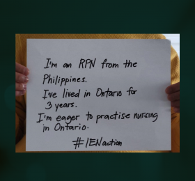 Person holding sign that says "I'm an RN from the Phillipines. I've lived in Ontario for 3 years. I'm eager to help and to practise nursing in Ontario. #IENAction