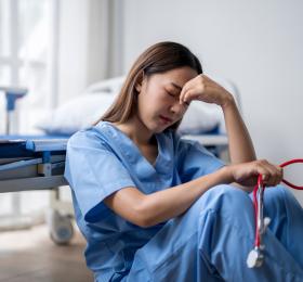 Stock image of exhausted health-care worker